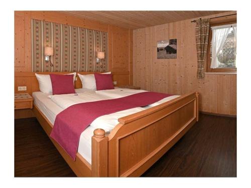 a bedroom with a large bed with red and white pillows at Holiday apartment with 2 bedrooms in Akams