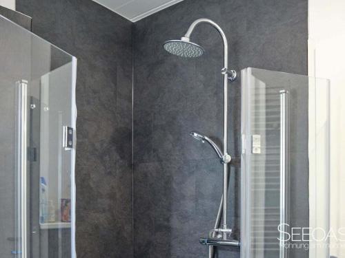 a shower with a glass door in a bathroom at Holiday apartment with 1 bedroom in Südrandweg