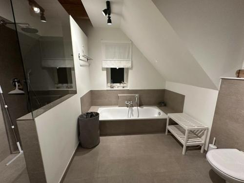 a bathroom with a bath tub and a sink at The Linnebargs, House 4 in Bisdorf