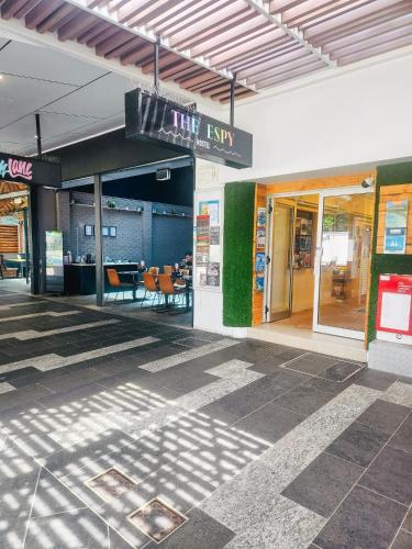 a building with a sign that reads the exit at The Espy Hostel in Cairns