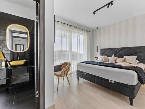 a bedroom with a bed and a sink and a mirror at Villa in Medulin with swimming pool in Premantura