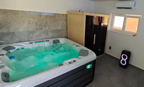 a bathroom with a large hot tub in a room at Family-friendly apartments with swimming pool Vinisce, Trogir - 12676 in Vinišće
