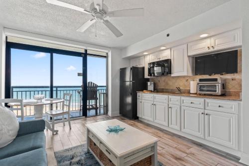 a kitchen and living room with a view of the ocean at Ocean Front at Beach Cove in Myrtle Beach