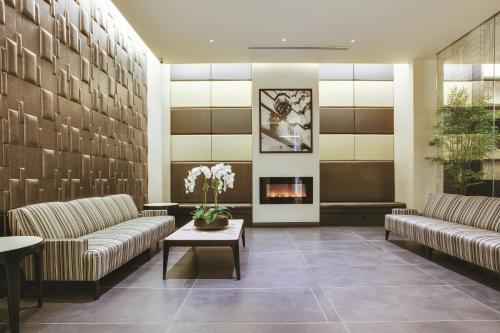 a lobby with two couches and a fireplace at The Hotel at Fifth Avenue in New York