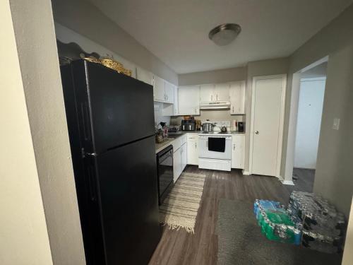 a kitchen with a black refrigerator and white appliances at Comfort zone in Indianapolis