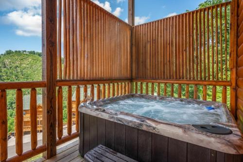 a hot tub on the deck of a cabin at Hibearnator in Sevierville