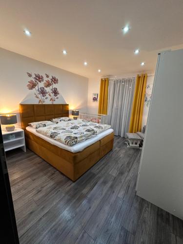 a bedroom with a large bed in a room at Villa Kulacs in Veľký Meder