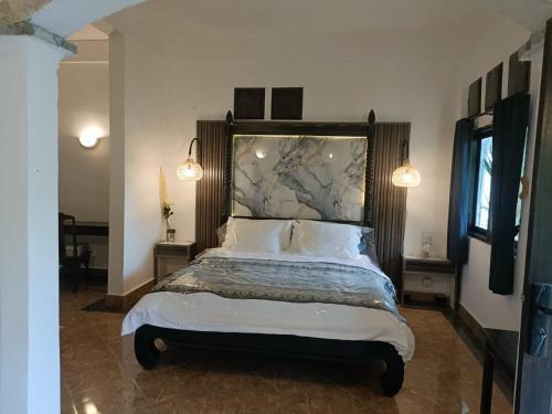 Postel nebo postele na pokoji v ubytování Village by the river