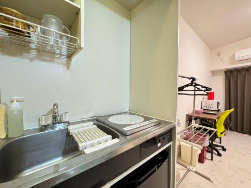 a kitchen with a sink and a counter top at A&C STAY Shin-Osaka in Osaka