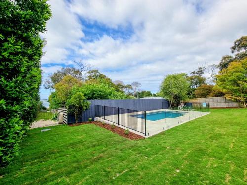 a swimming pool in a yard with a fence at Seaview Cottage and pool - Wifi and Linen included in Inverloch