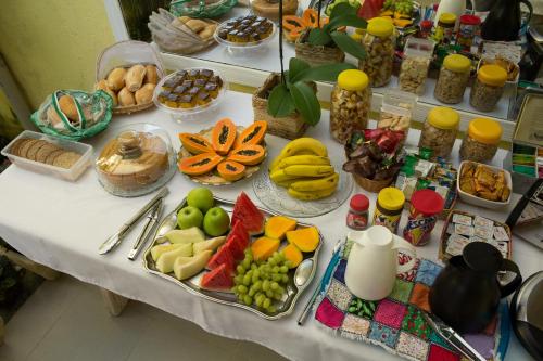 a table with many different types of food on it at Pousada Banzay in Paraty