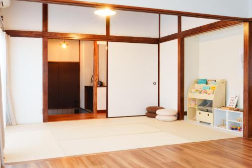 an open living room with a sliding glass door at ふとの情景 Futo Nostalgia in Ito