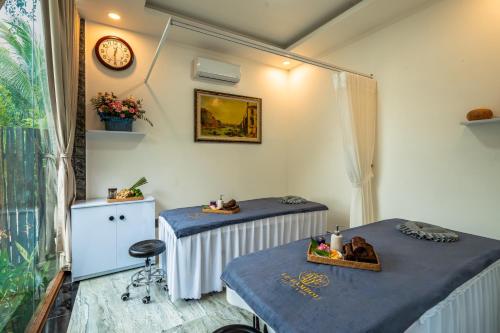 En eller flere senge i et værelse på Le Bambou Resort & Spa Phu Quoc