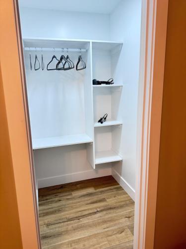 a closet with white shelves and glasses in it at NorthEdge Suites in Edmonton