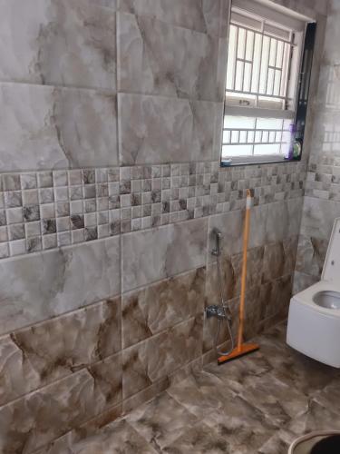 a bathroom with a shower and a toilet at Senthur Bavanam in Udumalaippettai