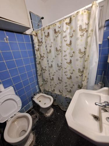 a bathroom with a toilet and a sink at Tucumán y Colón in Mar del Plata
