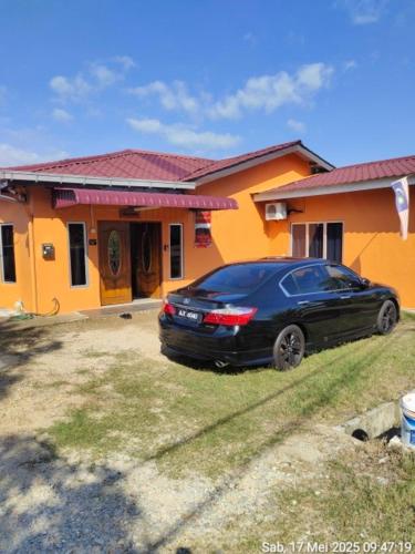 a black car parked in front of a house at Pagohhomestay Humaira282 in Pagoh