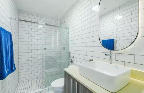 a white bathroom with a sink and a mirror at Stunning 1BR in Santa Ana Best Area in Panama City