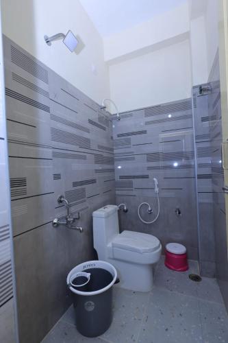 a bathroom with a toilet and a shower at TEMPLEVIEW RESIDENCy in Srikalahasti