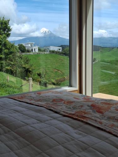 a window with a view of a snow covered mountain at Little Hurst House - Escape the Ordinary in Inglewood