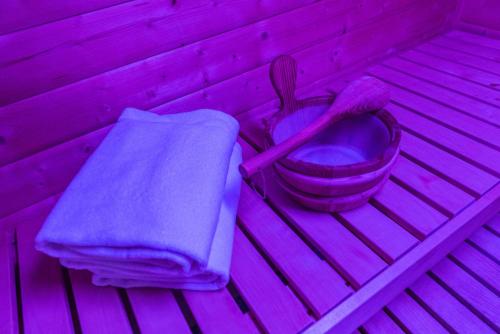 a purple room with a toilet and a towel at Hotel Krone Sihlbrugg in Sihlbrugg Dorf
