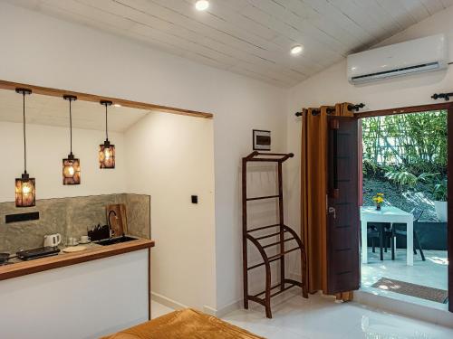 a kitchen with a ladder next to a table at Mellow Yellow Ahangama in Ahangama