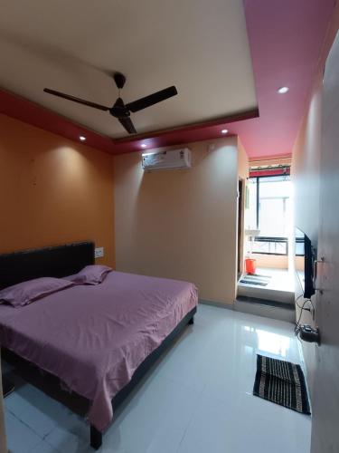 a bedroom with a bed and a ceiling fan at MTDC Shivtej in Kolhapur
