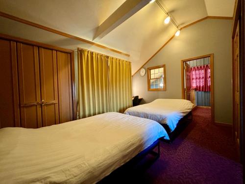 a bedroom with two beds and a window at Five room 120 SKY TREE SENSOJI FreeParking 1292sqft in Tokyo
