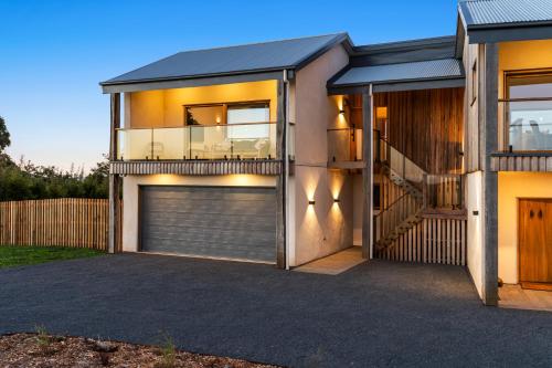 a house with a garage in front of it at Crater View Boutique Eco Apartment in Koroit