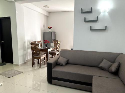 a living room with a couch and a table at Prime Residencies Panadura - Convenient Apartment in Panadura