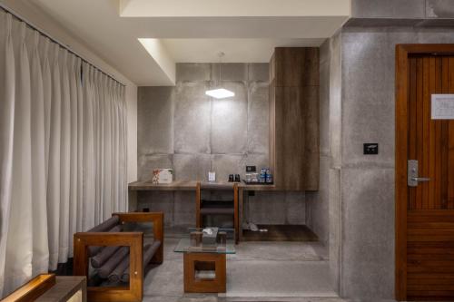 a living room with a table and a couch at De Glance Hotel, Near Surat Railway Station in Surat