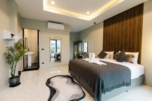 a bedroom with a large bed and a bathroom at La Villa Pool Krabi in Ban Khlong Chi Lat