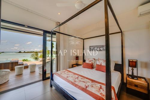 Un pat sau paturi într-o cameră la Penthouse 3 chambres Vue Lagon imprenable