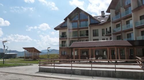 a large building with a porch in front of it at New Gudauri Sunny studio in Gudauri