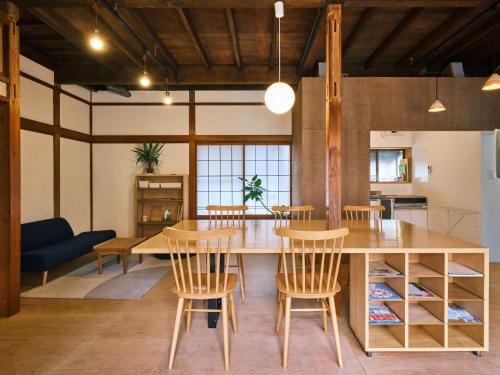a kitchen and dining room with a wooden table and chairs at 湊庵錆御納戸-so-an sabionand- in Higashiizu