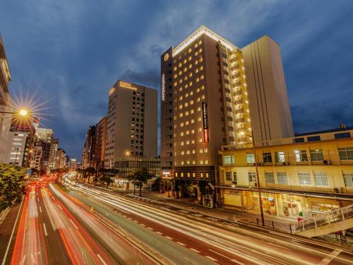 a city street with buildings and cars at night at APA Hotel Naha Matsuyama in Naha