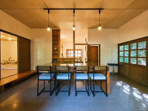 a dining room with a table and chairs at so-an morie in Higashiizu