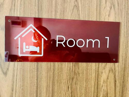 a red room sign on a wooden wall at Cozy Hideaway 2 BR in Ban Ta Khun
