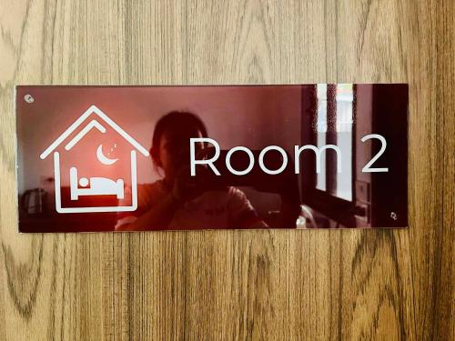 a sign on a door that says room at Cozy Hideaway 2 BR in Ban Ta Khun