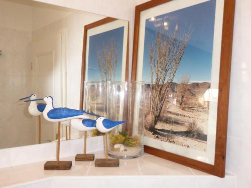 two statues of birds on a shelf in a room at Ferienwohnung Weißbach in Dresden