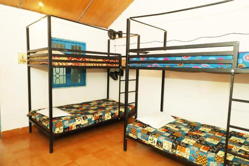 una stanza con tre letti a castello in una stanza di The Valley Arambol ad Arambol