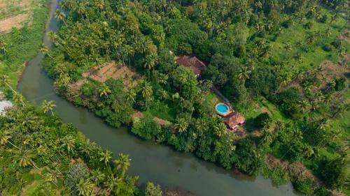an aerial view of a house next to a river at Seclude Karthika Nivas, Thrissur in Trichūr