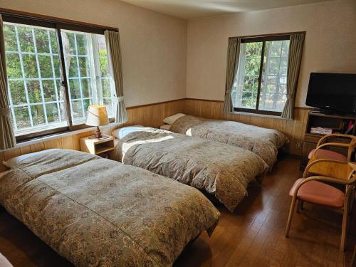 Ένα ή περισσότερα κρεβάτια σε δωμάτιο στο Pension Avenue