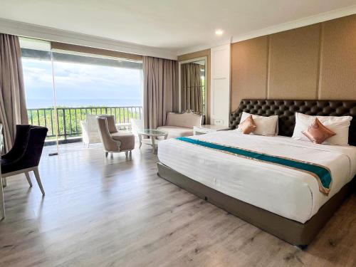 a bedroom with a large bed and a balcony at Ululani Bali in Uluwatu