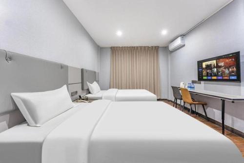 Postel nebo postele na pokoji v ubytování shenzhen kaixin Hotel