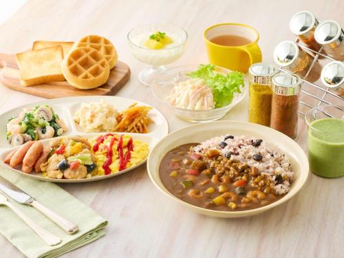 a table with three plates of food on it at Comfort Inn Kurashiki Mizushima in Kurashiki