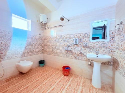 a bathroom with a sink and a toilet at ফোর স্কয়ার Four Square Lite Heaven Digha Near The Sea Beach in Digha