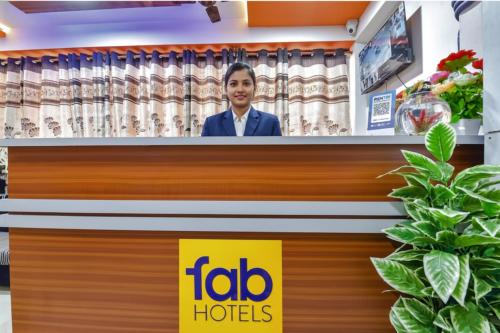 a ceo ofedia hotels stands behind a counter in a store at FabHotel Green Park in Ahmedabad