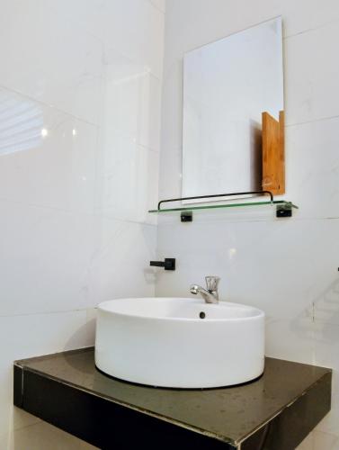 a bathroom with a sink and a mirror at Canberra Holidays - Mirissa in Mirissa