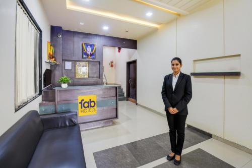 a man in a suit standing in a room at Via Sun n Shine in Pune